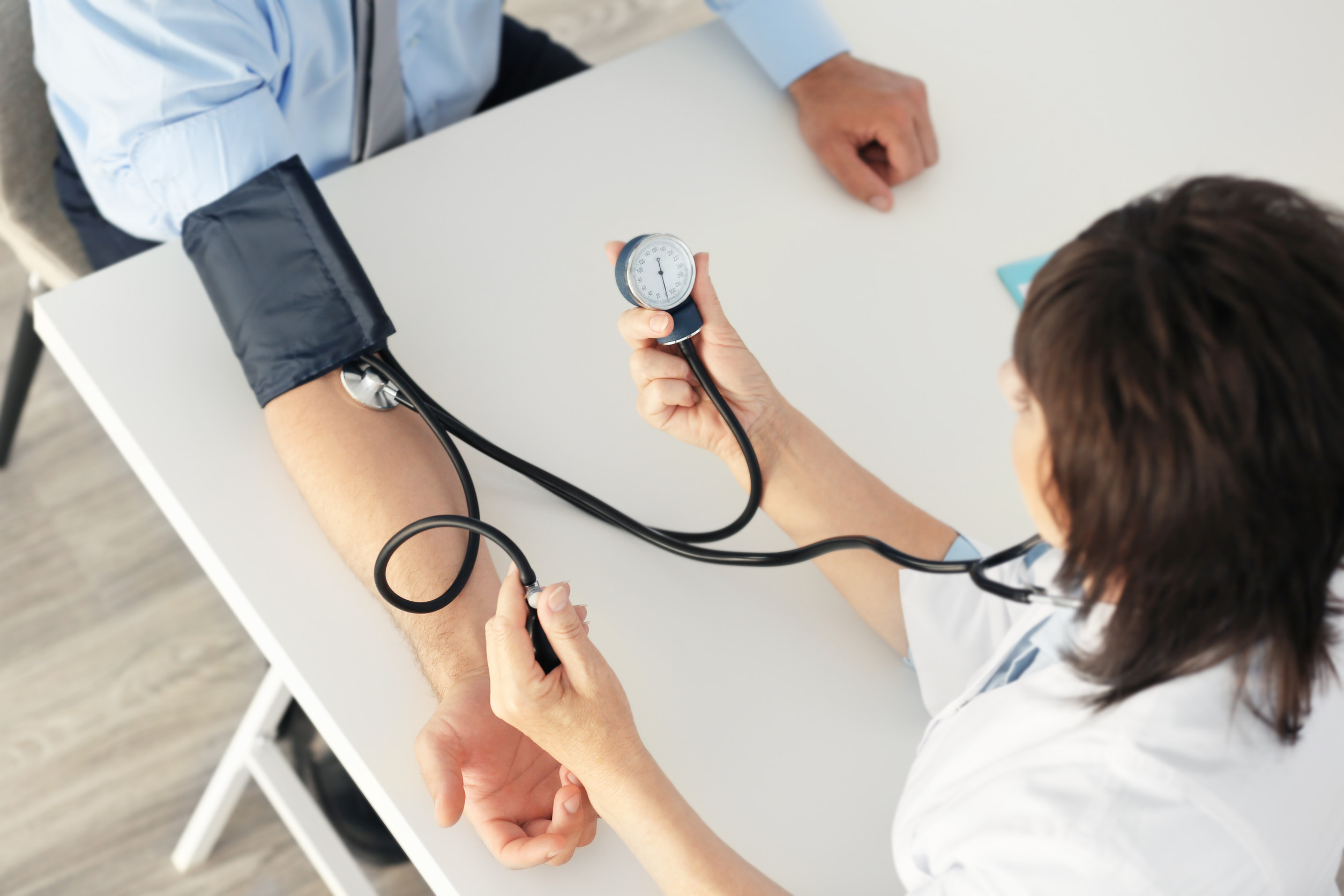 Doctor Checking Patient's Blood Pressure