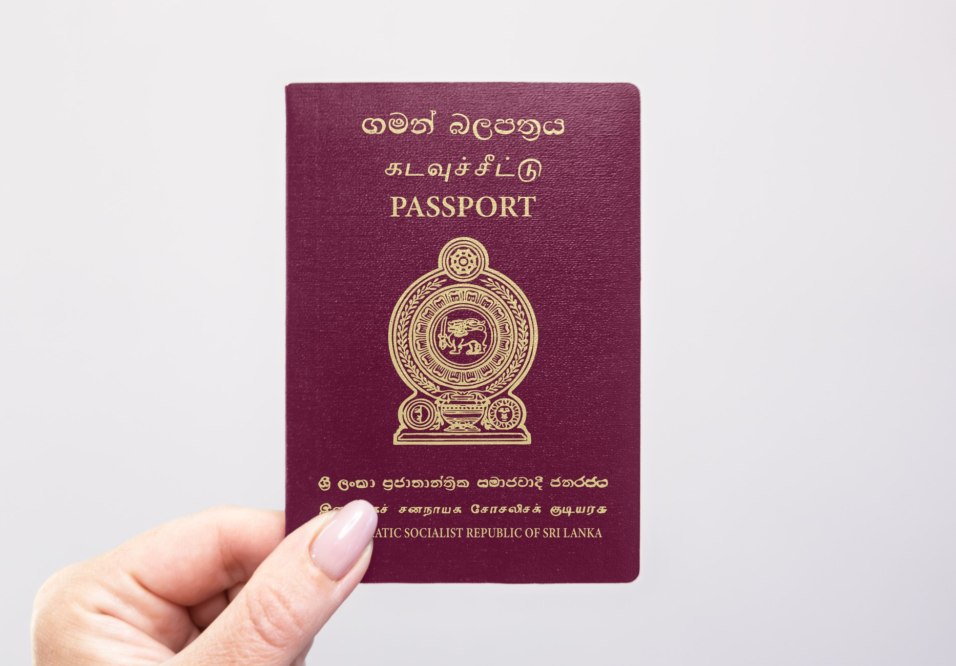 Hand holding a Sri Lankan passport