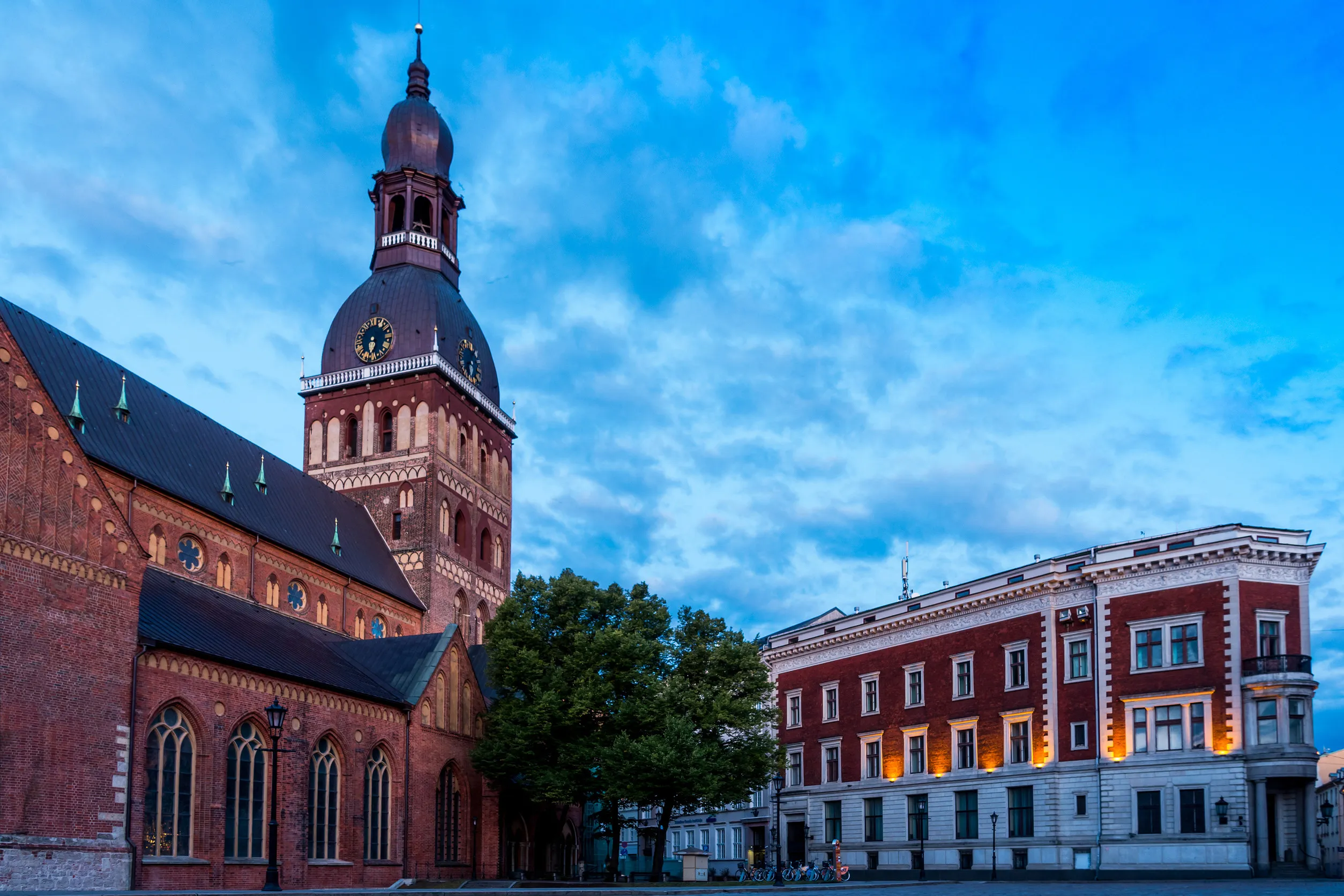 people on dome square with riga cathedral
