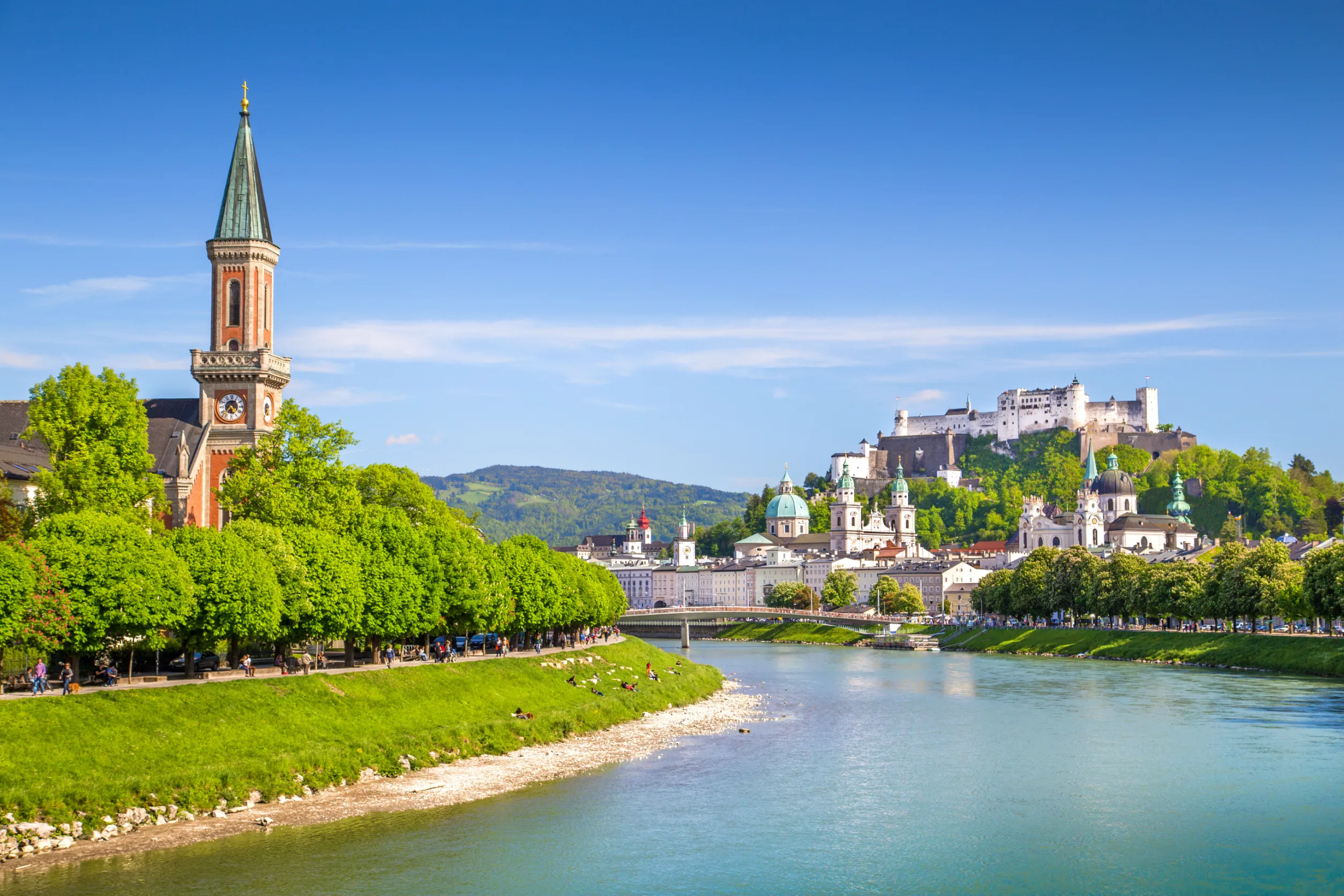 salzburg skyline with festung hohensalzburg and salzach river in summer