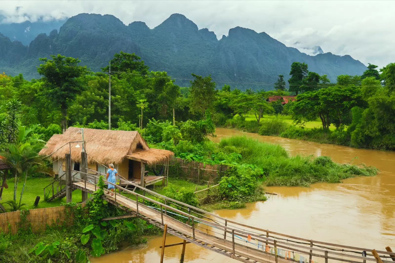 village hut near river in vangvieng laos